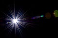 Flare wallpaper. Star spot or sun shine glow light on lens. Sunlight ray flash effect on black background. Optical Royalty Free Stock Photo