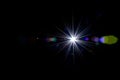 Flare wallpaper. Star spot or sun shine glow light on lens. Sunlight ray flash effect on black background. Optical Royalty Free Stock Photo