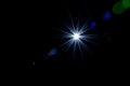 Flare wallpaper. Star spot or sun shine glow light on lens. Sunlight ray flash effect on black background. Optical leaking Royalty Free Stock Photo
