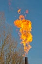 Flaring flames against a blue sky