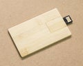 Flash drive card on brown cardboard texture background.  USB stick made from wood material concept Royalty Free Stock Photo