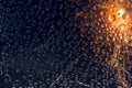 Flash of explosion is reflected in transparent water droplets against the background of the night sky. Royalty Free Stock Photo