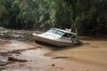 flash flood causes a boat to capsize and float downstream Royalty Free Stock Photo