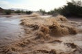 flash flood in a desert, with the water rushing through the sand Royalty Free Stock Photo