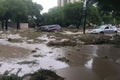 flash flood overtaking city park, with debris and cars floating in the water Royalty Free Stock Photo