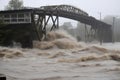 flash flood roars past bridge, with water levels rising and threatening to topple the structure