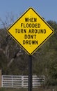 Flash flood sign says When Flooded Turn Around Don`t DrownFlash flood sign says When Flooded Turn Around Don`t Drown Royalty Free Stock Photo