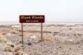 Flash Floods warning sign warns motorists of potential dangerous flooding on roads during rain and monsoon season in California`s Royalty Free Stock Photo