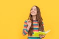 Flash of genius. Happy girl hold copybook pointing pen up. Child genius yellow background Royalty Free Stock Photo