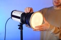 A flash with a modifier on with a diffuser with a person Royalty Free Stock Photo