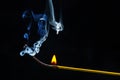 Flashed and burning wooden match on a dark background close-up. Bright fire and smoke from a burning tree Royalty Free Stock Photo