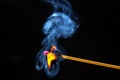 Flashed and burning wooden match on a dark background close-up. Bright fire and smoke from a burning tree Royalty Free Stock Photo