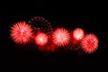 Flashes of fireworks of red color against the black sky Royalty Free Stock Photo