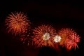Flashes of orange and white fireworks against black sky Royalty Free Stock Photo