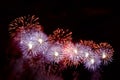 Flashes of red and purple fireworks against black sky Royalty Free Stock Photo