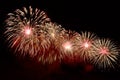 Flashes of red and white fireworks against black sky Royalty Free Stock Photo