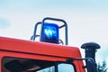 Flashing blue light on a fire truck in duty, part of the vehicle, copy space in the sky, motion blur Royalty Free Stock Photo