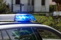 Flashing blue lights on a police car on duty, part of the vehicle, copy space