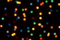 Flashing bokeh lights circles on decorative garland on black background.