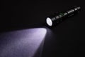 Flashlight and beam of light on a dark background Royalty Free Stock Photo