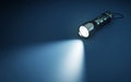 Flashlight and beam of light on a dark background Royalty Free Stock Photo