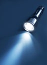 Flashlight and beam of light on a dark background Royalty Free Stock Photo