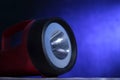 Flashlight, close up, under dark blue background with light beam Royalty Free Stock Photo