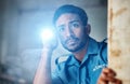 Flashlight, security guard and man in dark room for investigation, inspection and property search at night. Surveillance