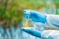 A flask with water from a lake in the hands of a environmentalist chemist