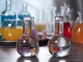 Flasks with clear water. Laboratory glassware with colorful liquids on the table Royalty Free Stock Photo