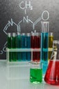 Flasks and test tubes with liquid on background laboratory. Royalty Free Stock Photo