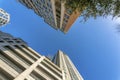 Flat or apartment and parking garage building with trees and cloudless blue sky