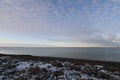 Flat arctic landscape in late fall with snow on the ground and blue skies