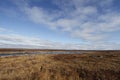 Flat arctic landscape in the summer with blue skies and soft clouds