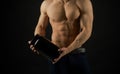 The flat belly diet. Strong man hold vitamin bottles. Vitamin nutrition. Man with six pack. Stimulating muscle growth