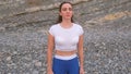 Flat belly girl during diaphragmatic breathing exercises bodyflex on the rock background. Face and body close-up view.