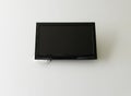 Flat black LED TV mounted on a white wall Royalty Free Stock Photo