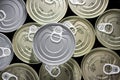 Flat bottom with many cans of golden tuna and a silver color tuna can up side Royalty Free Stock Photo