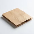 A flat brown paper bag lies on a white surface. The bag is neatly folded, showcasing Royalty Free Stock Photo