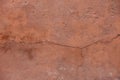 flat brown plaster wall with long crack