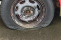 flat car tire close up, punctured wheel. A punctured tire while traveling by car. Replacing a punctured wheel