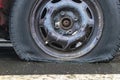 flat car tire close up, punctured wheel. A punctured tire while traveling by car. Replacing a punctured wheel