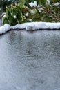 Flat carport roof covered in snow, slush, ice, and water, with clogged downspout drain Royalty Free Stock Photo