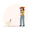 Happy young woman feeding a hen and the baby chick.