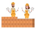 Couple of brick builder team in a yellow protective hardhat.