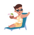 Flat child on summer holidays at beach. Cute boy sitting on lounge with tropical cocktail in coconut. Tourist relax at Royalty Free Stock Photo