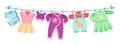 Flat children clothes. Colorful dresses, little kid unisex apparel on clothesline. Isolated element for birthday or baby Royalty Free Stock Photo