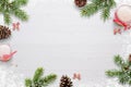 Flat Christmas background scene with fir branches, bows, candles, pinecones and snowflakes Free space for copy text on white board Royalty Free Stock Photo