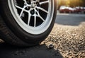 flat close tire track rear suv punctured white vehicle car automobile residential summer nail day street depth selective focus Royalty Free Stock Photo