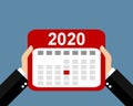 Two hands holding calendar showing appointments and events in 2020